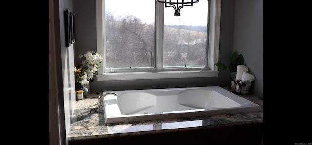 bathroom with a relaxing tiled tub