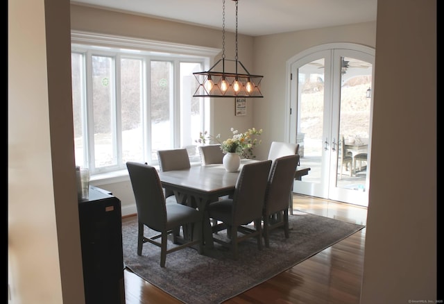 dining space featuring french doors and dark wood-type flooring