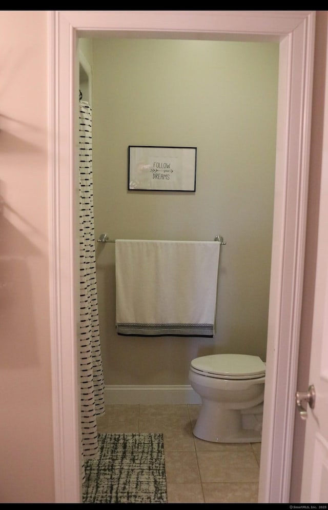 bathroom with tile patterned flooring and toilet