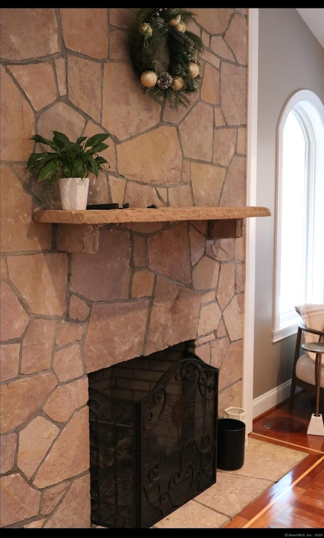 room details featuring hardwood / wood-style floors and a large fireplace