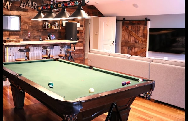 1461 Bunker Hill Rd, Watertown, CT 06795 - game room featuring a barn door, vaulted ceiling, pool table, a dry bar, and wood finished floors