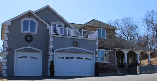 1461 Bunker Hill Rd, Watertown, CT 06795 - view of front of property featuring driveway, a balcony, stone siding, stucco siding, and a garage