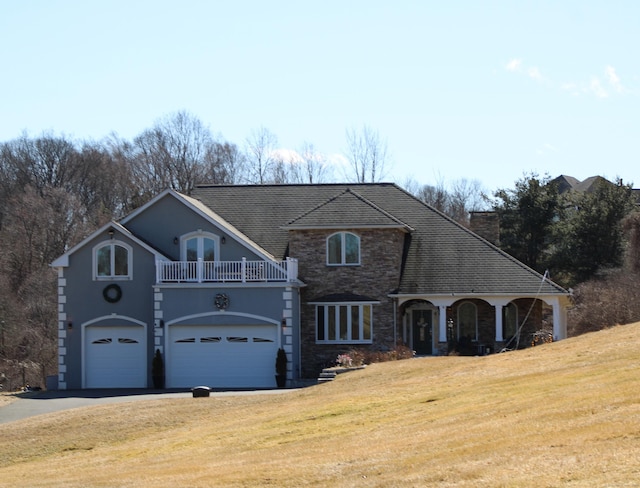 1461 Bunker Hill Rd, Watertown, CT 06795 - view of front of house with a front yard, a garage, a balcony, driveway, and stone siding