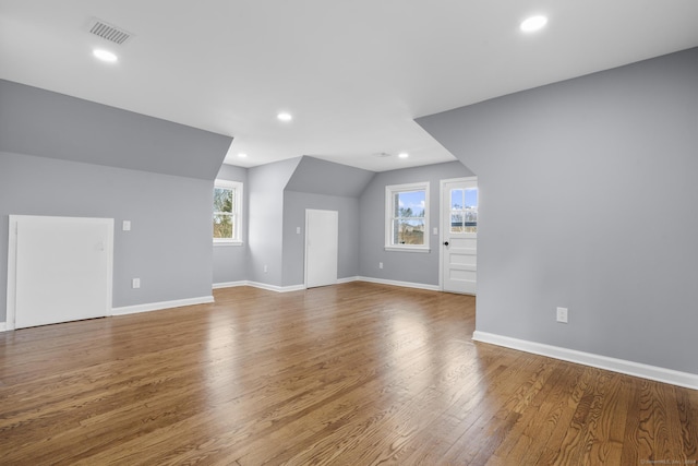 bonus room featuring hardwood / wood-style flooring, plenty of natural light, and lofted ceiling