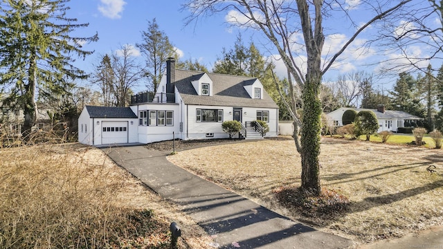 new england style home with a garage and an outbuilding