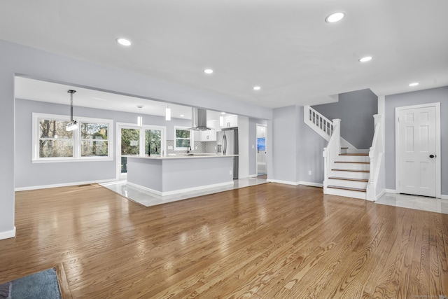 unfurnished living room with light hardwood / wood-style floors