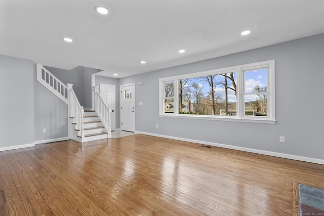 unfurnished living room featuring light wood-type flooring