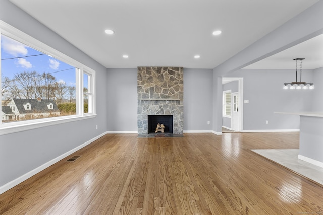 unfurnished living room with a fireplace and wood-type flooring