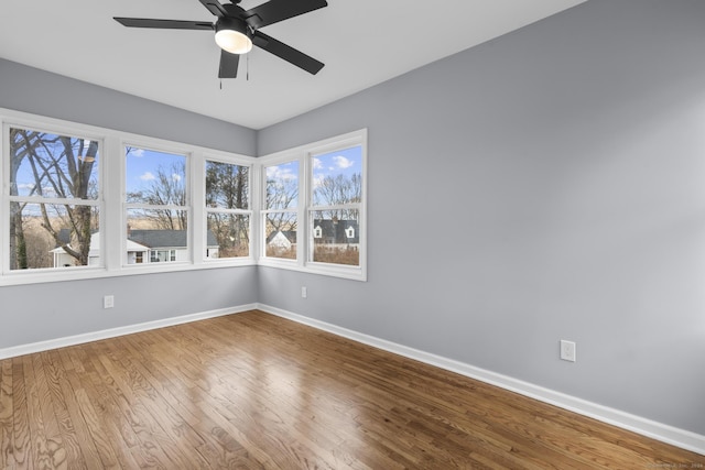 unfurnished room with hardwood / wood-style floors and ceiling fan