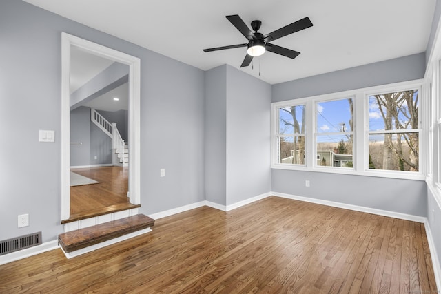 spare room with ceiling fan and hardwood / wood-style floors