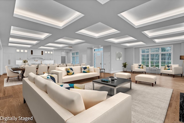 living room with beamed ceiling, wood-type flooring, and coffered ceiling