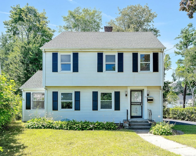 colonial home with a front lawn