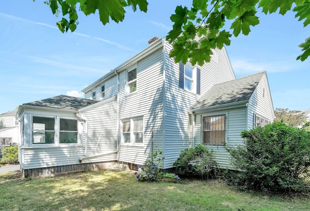 view of property exterior featuring a lawn