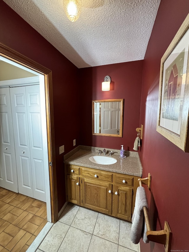 bathroom with vanity, wood-type flooring, and a textured ceiling