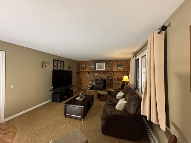 living room featuring carpet flooring, a wood stove, and a baseboard heating unit