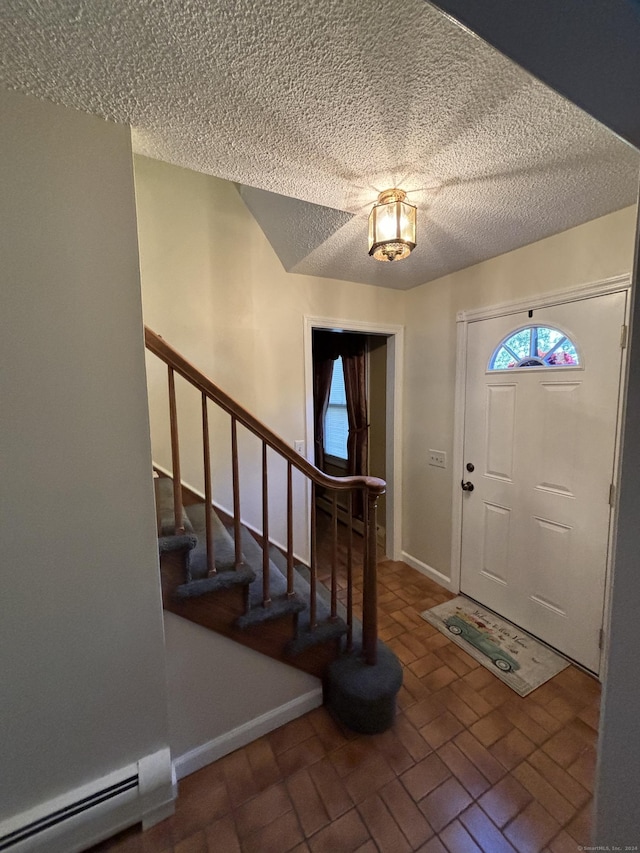 foyer with a textured ceiling and a baseboard radiator