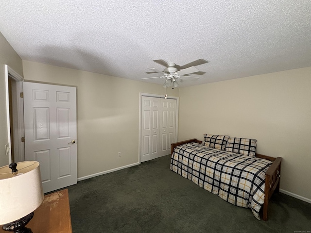 carpeted bedroom with ceiling fan, a closet, and a textured ceiling