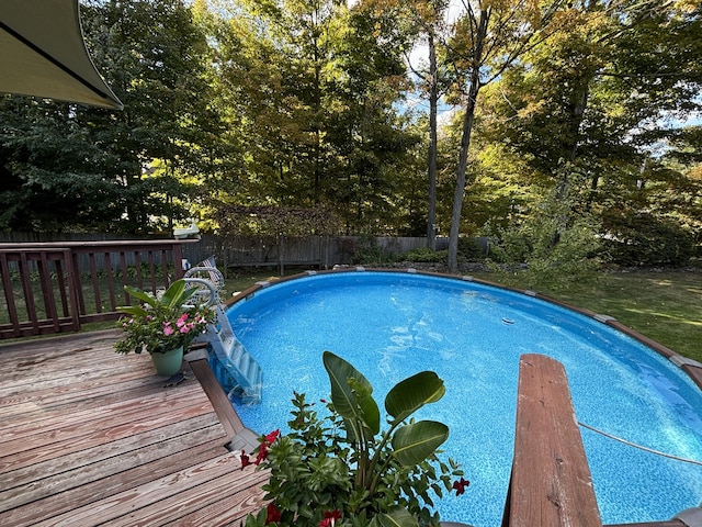 view of swimming pool with a deck