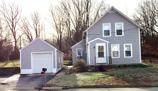 view of front facade with an outbuilding and a garage