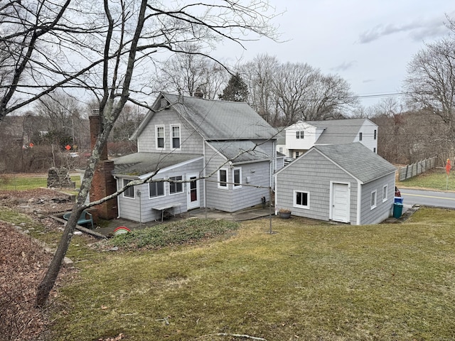 back of house with a lawn