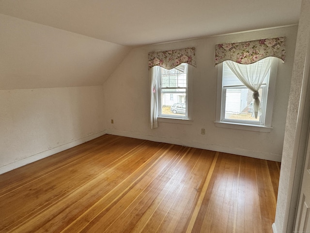 bonus room with wood-type flooring and lofted ceiling