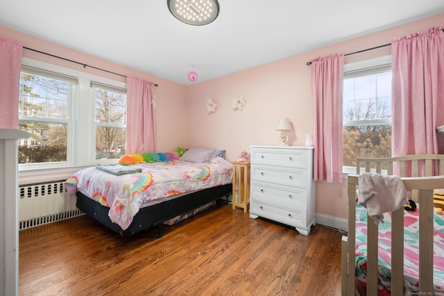 bedroom featuring dark hardwood / wood-style floors and radiator