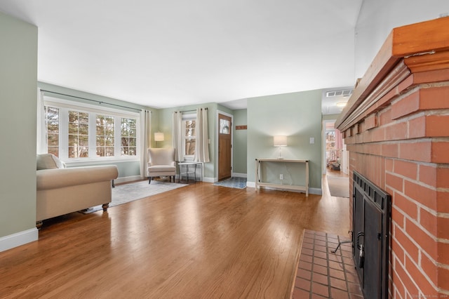 unfurnished living room with a fireplace and hardwood / wood-style flooring