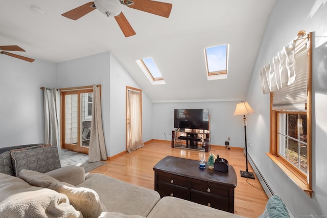 living room with ceiling fan, a baseboard radiator, light hardwood / wood-style floors, and lofted ceiling with skylight