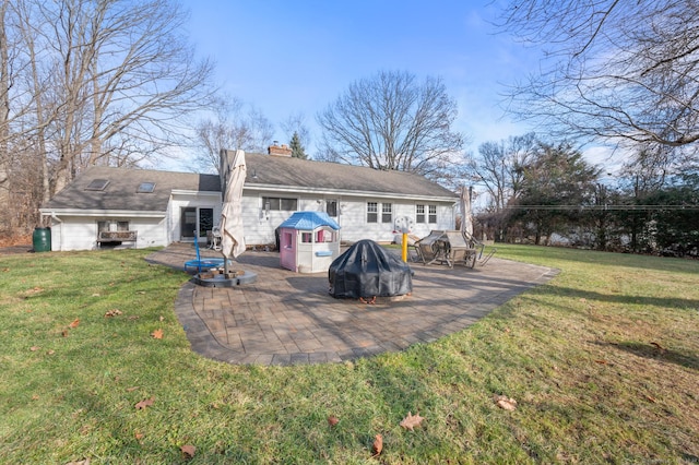 rear view of property with a patio area and a yard