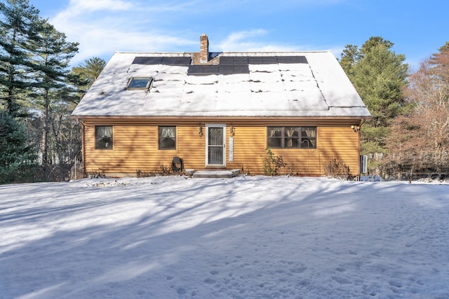 view of snow covered back of property