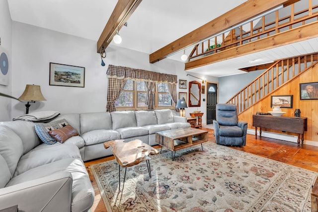 living room with beamed ceiling, wood walls, wood-type flooring, and baseboard heating