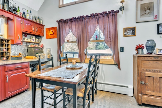 dining area with plenty of natural light, a baseboard radiator, and lofted ceiling