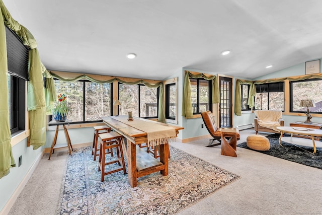 dining space featuring baseboard heating, light carpet, and vaulted ceiling