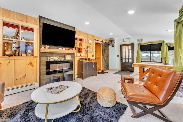 living room with a baseboard radiator, a barn door, wood walls, lofted ceiling, and light carpet