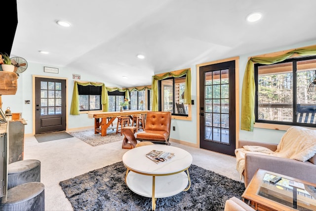 living room featuring light colored carpet and vaulted ceiling