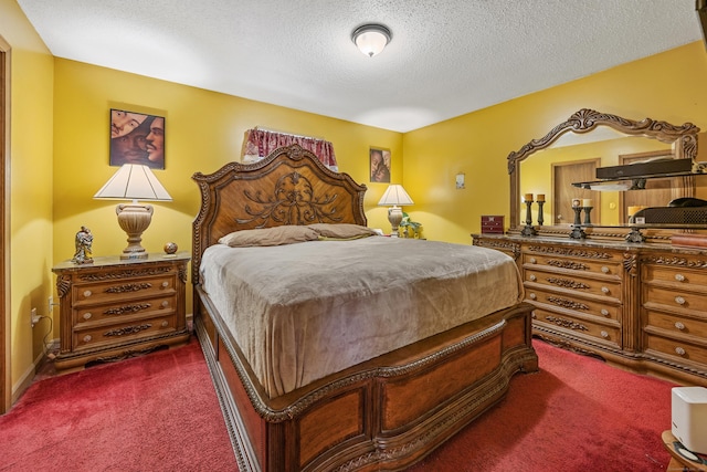 bedroom featuring a textured ceiling and dark carpet