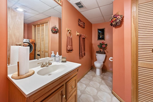 bathroom with a closet, a paneled ceiling, toilet, and visible vents