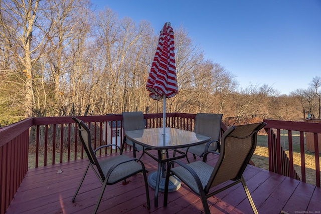 wooden terrace with outdoor dining area