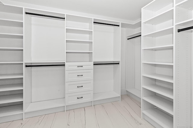 spacious closet with marble finish floor