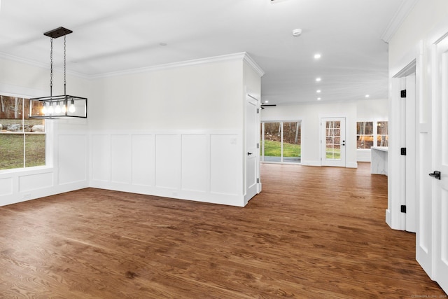 interior space featuring a chandelier, dark hardwood / wood-style floors, a wealth of natural light, and crown molding