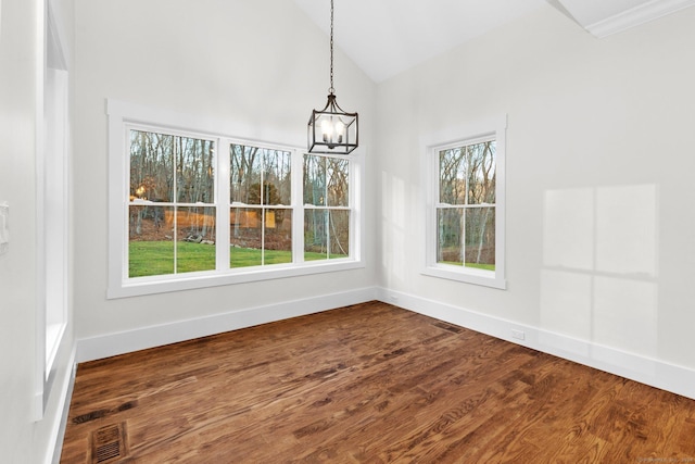 unfurnished dining area featuring a notable chandelier, dark wood finished floors, visible vents, and baseboards