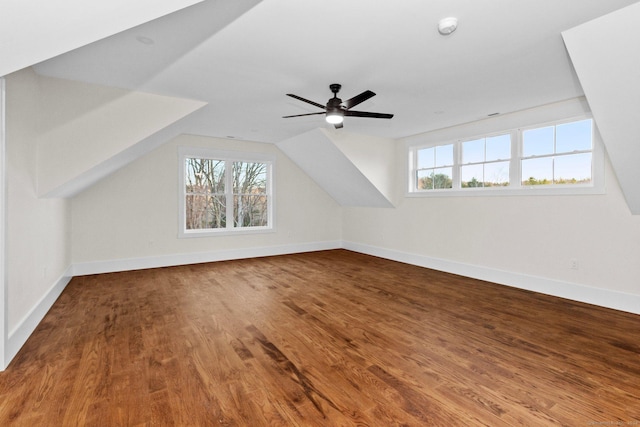 additional living space featuring ceiling fan, plenty of natural light, vaulted ceiling, and hardwood / wood-style flooring