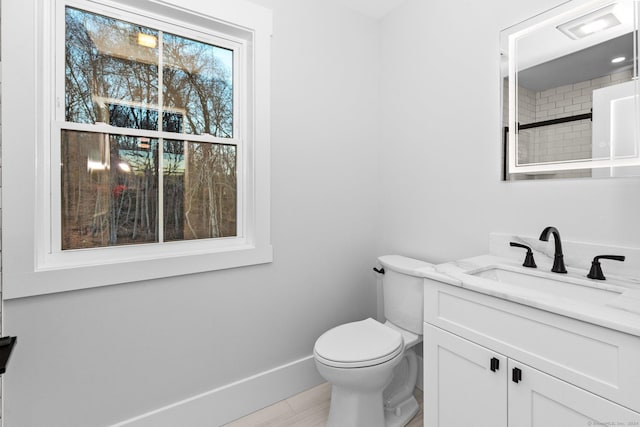 bathroom featuring a shower, vanity, and toilet