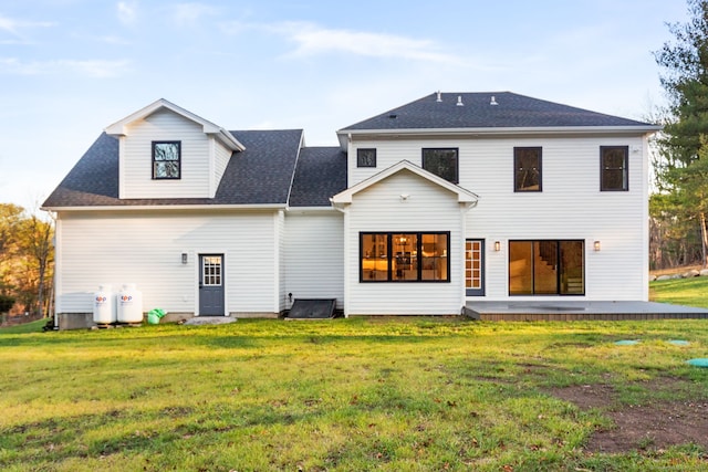 rear view of property with a lawn and a patio