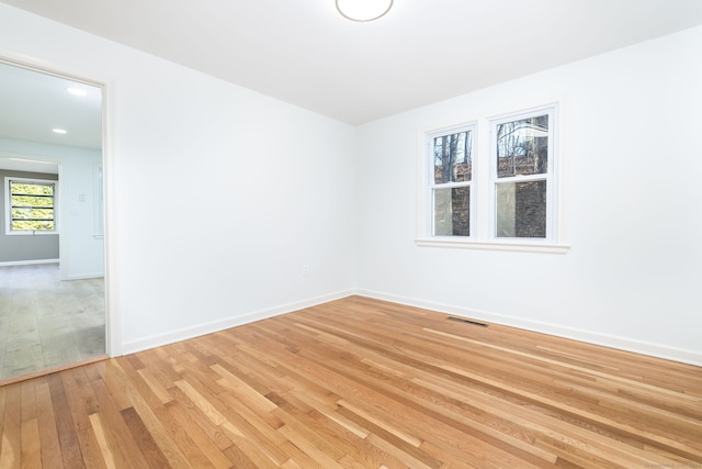 spare room with light wood-type flooring