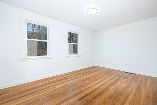 unfurnished room with hardwood / wood-style floors