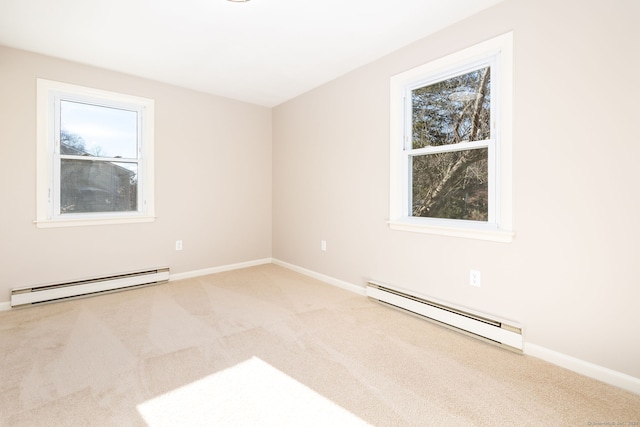 unfurnished room with carpet floors, a healthy amount of sunlight, and a baseboard heating unit