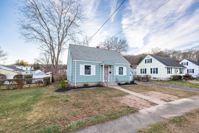 bungalow featuring a front yard