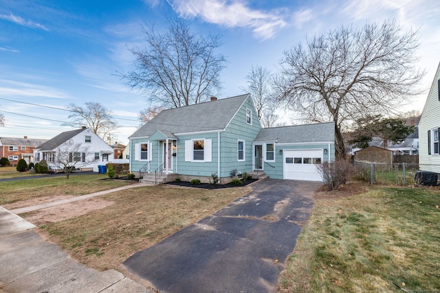 bungalow-style home featuring a garage and a front yard