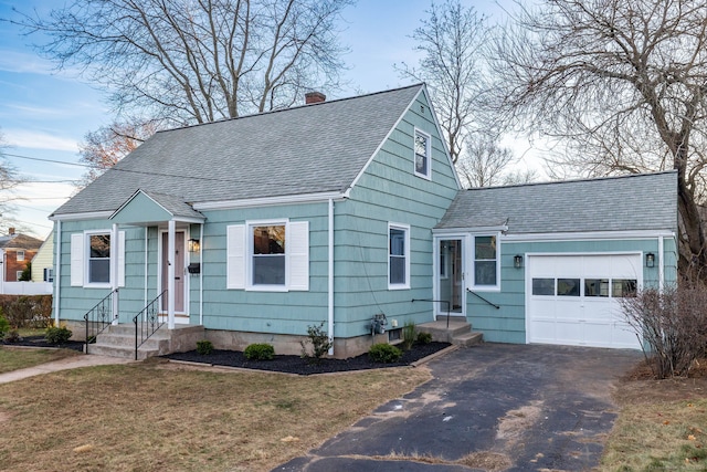 view of front of house with a front yard and a garage